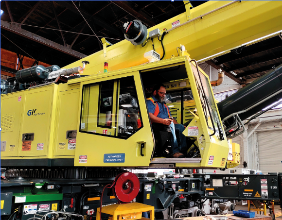 Railway cranes in operation at various rail infrastructure sites, demonstrating their capability to efficiently handle lifting tasks at underpasses, bridges, substations, and trackside structures.